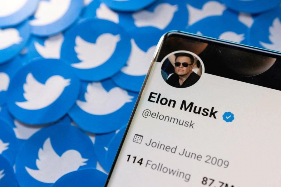 Elon Musk's Twitter profile is seen on a smartphone placed on printed Twitter logos in this picture illustration taken April 28, 2022. REUTERS/Dado Ruvic/Illustration