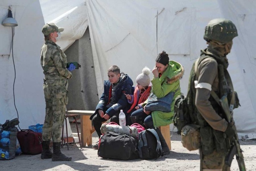 A woman sits with children as evacuees, including civilians who left the area near Azovstal steel plant in Mariupol, arrive at a temporary accommodation centre during Ukraine-Russia conflict in the village of Bezimenne in the Donetsk Region, Ukraine on May 1, 2022 — Reuters photo