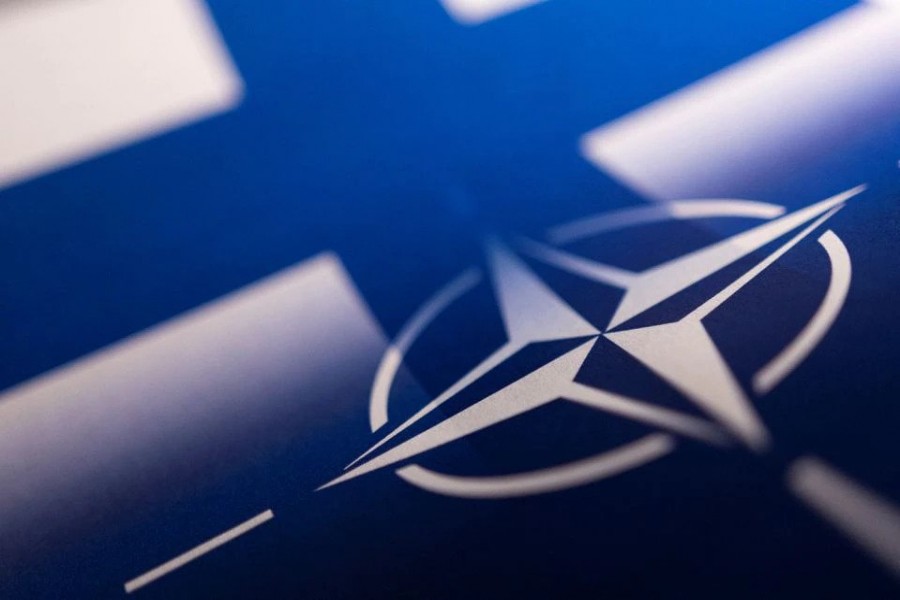 Finnish and NATO flags are seen printed on paper this illustration taken April 13, 2022. REUTERS/Dado Ruvic/Illustration