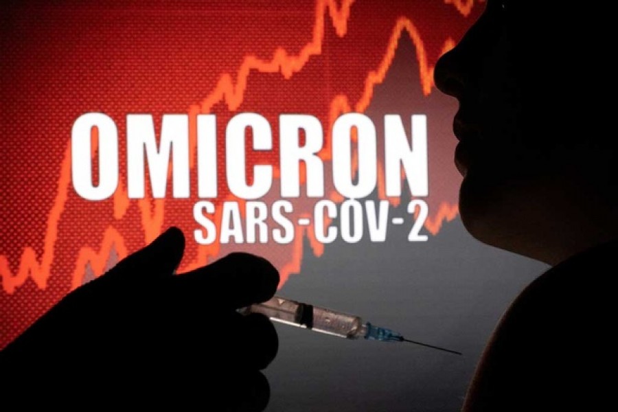 People pose with a syringe in front of displayed words "OMICRON SARS-COV-2" in this illustration taken, December 11, 2021 — Reuters/Files