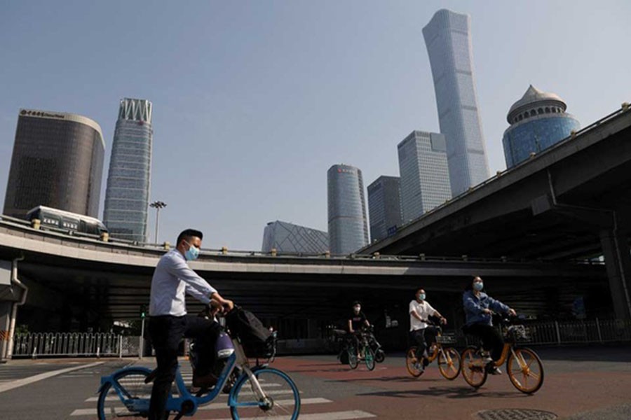 People ride shared bicycles during morning rush hour at the Central Business District (CBD), following a work-from-home order for residents of Chaoyang district amid the coronavirus disease (COVID-19) outbreak, in Beijing, China May 5, 2022. REUTERS/Tingshu Wang