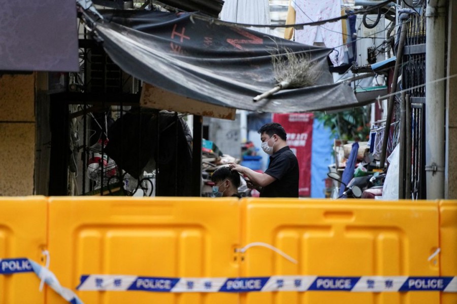 A resident gets a haircut at a closed residential area during lockdown amid the coronavirus disease (COVID-19) pandemic, in Shanghai, China, May 5, 2022. REUTERS/Aly Song