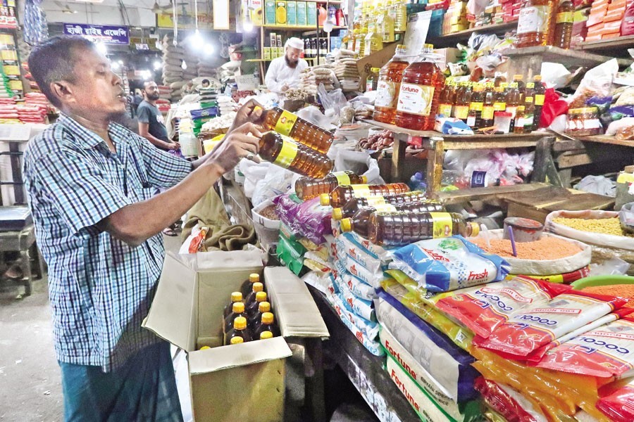 Amid severe soybean oil supply crisis in the market, this trader at Karwan Bazar in Dhaka city is seen arranging mustard oil bottles to be sold as an alternative to soybean oil. The photo was taken on Friday — FE photo