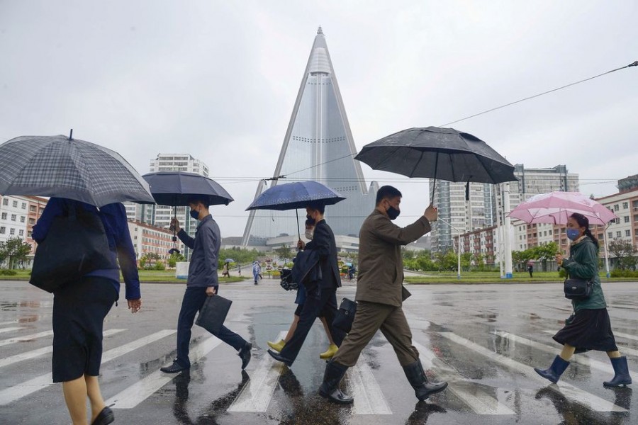 People wearing protective face masks walk amid concerns over the new coronavirus disease (COVID-19) in Pyongyang, North Korea May 15, 2020, in this photo released by Kyodo. Mandatory credit Kyodo/via REUTERS