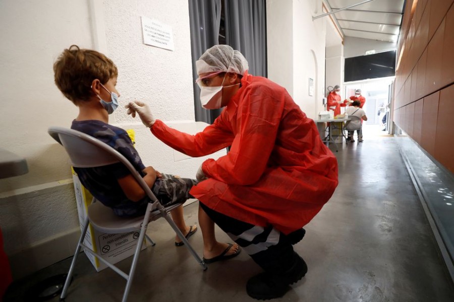 A firefighter from the Marins-Pompiers of Marseille (Marseille Naval Fire Battalion) administers a nasal swab to a child at a testing site for coronavirus disease (Covid-19) in Marseille, France on September 17, 2020 — Reuters/Files