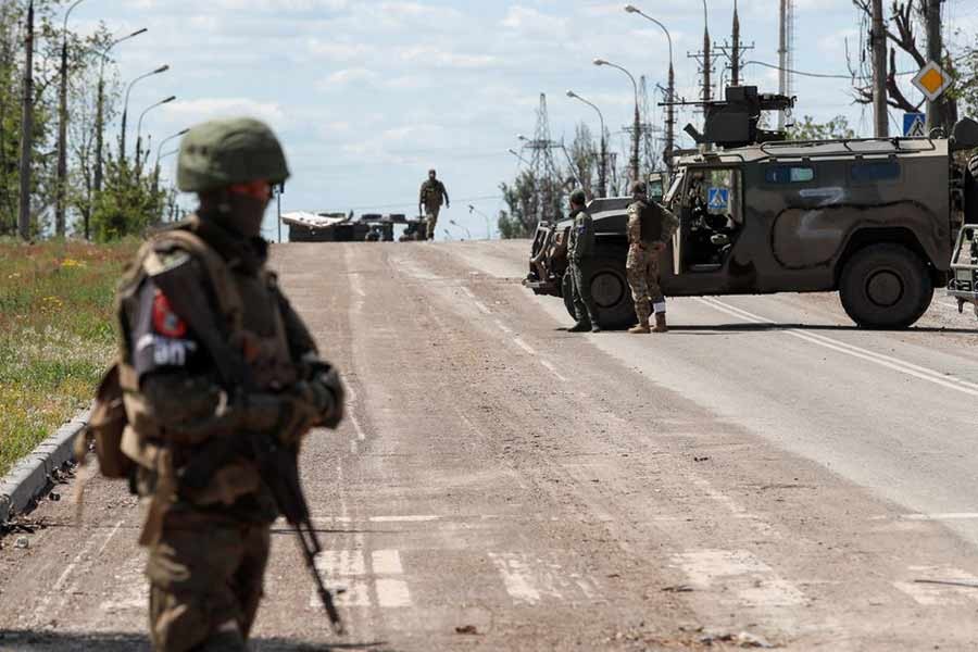 Service members of pro-Russian troops standing guard on a road before the expected evacuation of wounded Ukrainian soldiers from the besieged Azovstal steel mill in the course of Ukraine-Russia conflict in Mariupol of Ukraine on Monday –Reuters photo