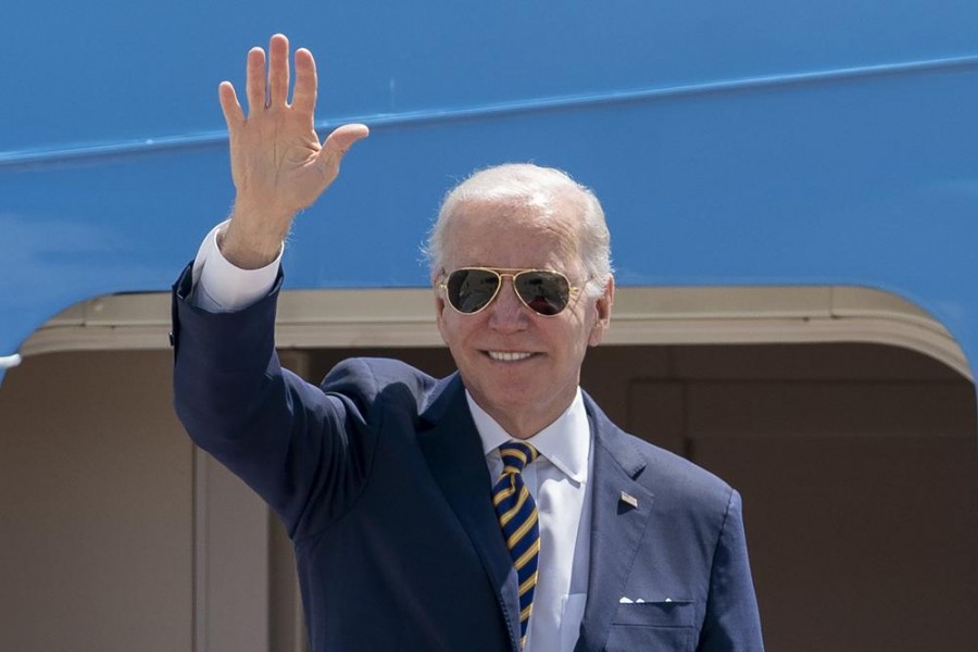 FILE - President Joe Biden waves as he boards Air Force One for a trip to South Korea and Japan, on May 19, 2022, at Andrews Air Force Base, Md. China is holding military exercises in the disputed South China Sea coinciding with U.S. President Joe Biden’s visits to South Korea and Japan that are largely focused on countering the perceived threat from China. (AP Photo/Gemunu Amarasinghe, File)