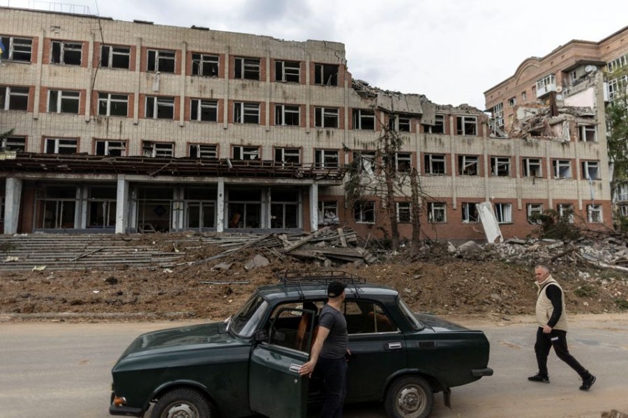 A local resident walks by a destroyed building after a rocket attack on a university campus, amid Russia's invasion, in Bakhmut, in the Donetsk region, Ukraine, May 21, 2022. REUTERS/Carlos Barria