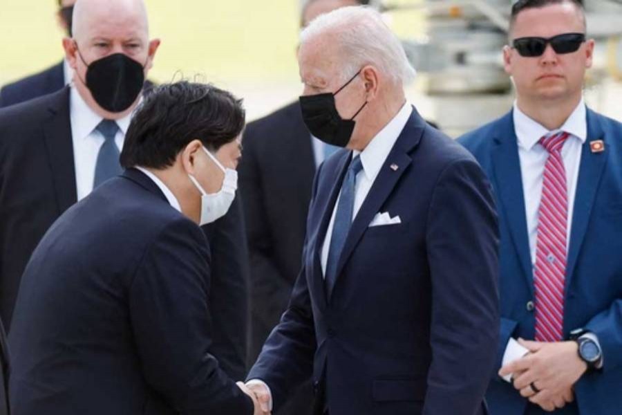 US President Joe Biden shakes hands with Japanese Foreign Minister Yoshimasa Hayashi upon his arrival Japan May 22, 2022. (Reuters)  