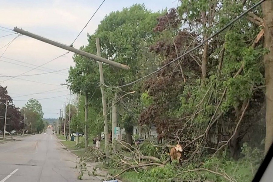 Damaged utility poles and trees are seen in the aftermath of a storm in Uxbridge, Ontario, Canada on May 21, 2022 in this screen grab taken from a social media video — Blake Wagner via REUTERS
