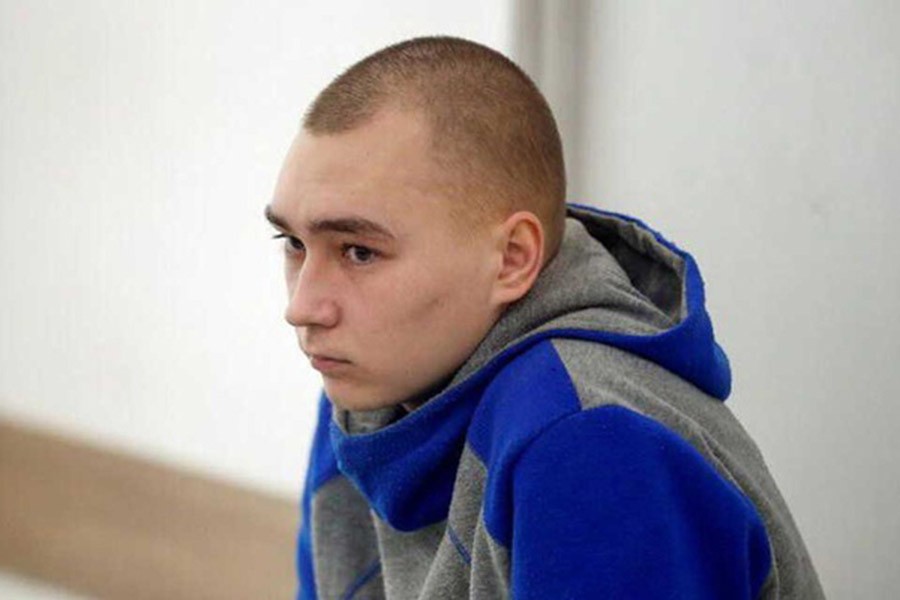 Russian soldier Vadim Shishimarin, 21, suspected of violations of the laws and norms of war, sits inside a cage during a court hearing, amid Russia's invasion of Ukraine, in Kyiv, Ukraine May 23, 2022. Reuters