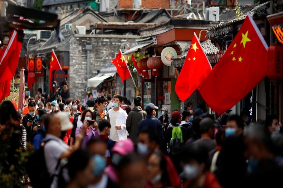 People walk in the tourist area surrounding Houhai Lake during Chinese National Day holidays in Beijing, China, October 2, 2020 - REUTERS