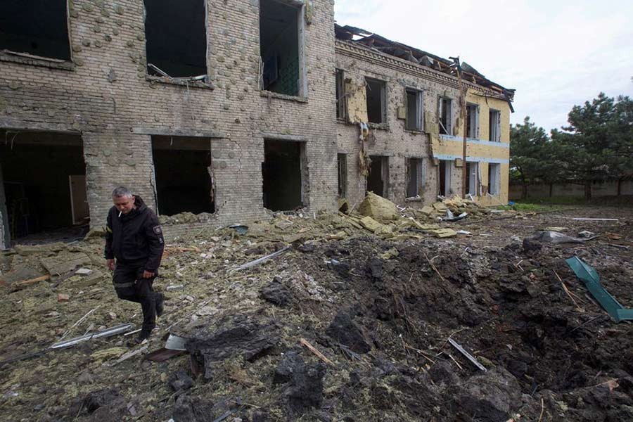A police officer walking next to a school building damaged by a Russian military strike, as Russia's attack on Ukraine continues, in the settlement of Kostiantynivka in Donetsk region of Ukraine recently –Reuters file photo