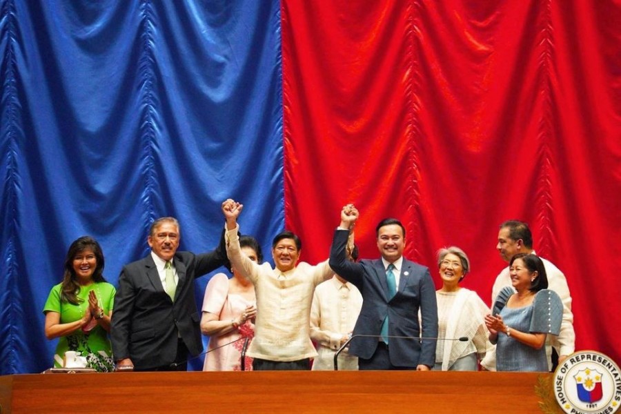 Philippine President-elect Ferdinand "Bongbong" Marcos Jr. raises hands with Senate President Vicente Sotto III and House Speaker Lord Allan Velasco during his proclamation, at the House of Representatives, in Quezon City, Metro Manila, Philippines, May 25, 2022. BBM Media Bureau/Handout via REUTERS ATTENTION