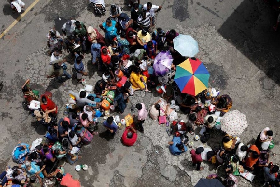 People wait in a queue to buy kerosene at a fuel station, amid the country's economic crisis in Colombo, Sri Lanka, May 18, 2022. REUTERS/Adnan Abidi