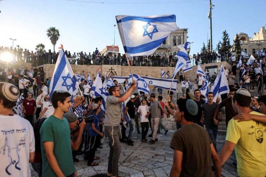 Israelis dance with flags by Damascus gate just outside Jerusalem's Old City Jun 15, 2021. Reuters