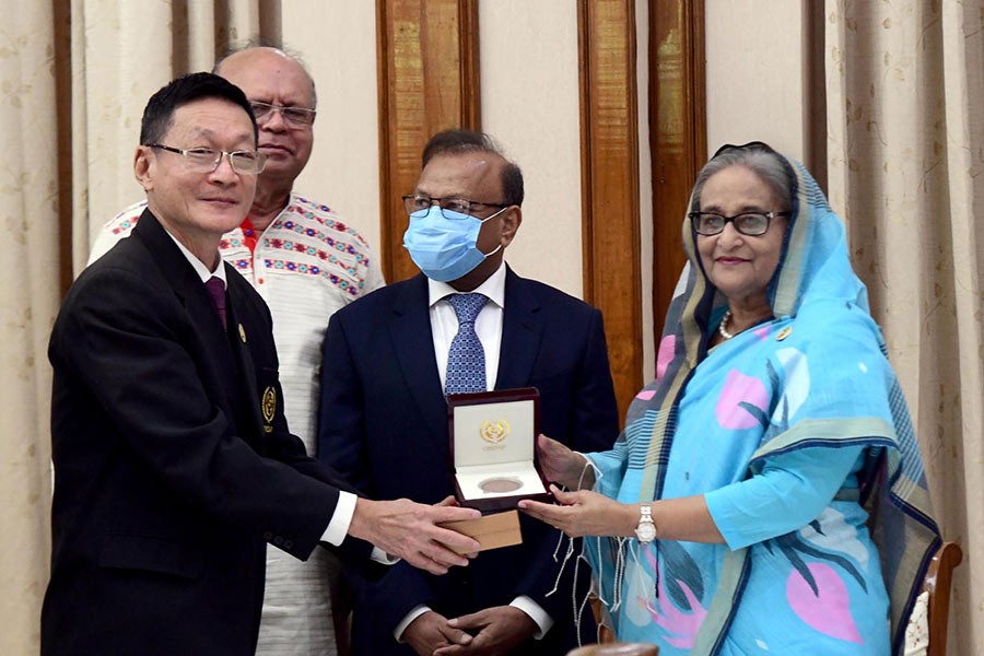 Prime Minister Sheikh Hasina receiving “Azizul Haque Polli Unnayan Padak-2021” from CIRDAP Director-General Dr Cherdsak Virapat at a ceremony at Ganabhaban on Sunday –PID Photo