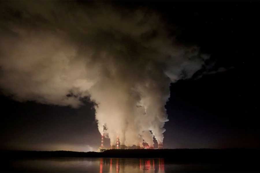 Smoke and steam billowing from Belchatow Power Station, Europe's largest coal-fired power plant, at night near Belchatow of Poland in 2018 –Reuters file photo