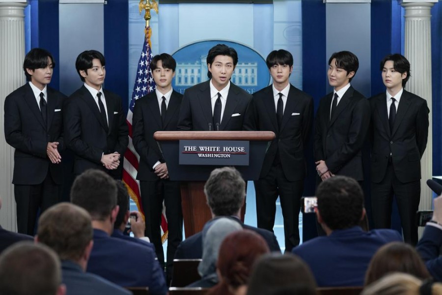 RM, center, accompanied by other K-pop supergroup BTS members from left, V, Jungkook, Jimin, Jin, J-Hope, and Suga speaks during the daily briefing at the White House in Washington, Tuesday, May 31, 2022. (AP Photo/Evan Vucci)