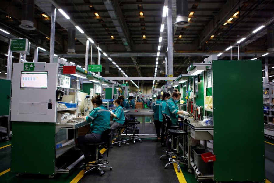 Employees work on the production line during an organised media tour to a Schneider Electric factory in Beijing, China February 17, 2022. REUTERS/Florence Lo