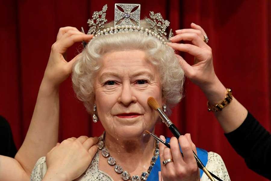 Studio artists retouching a wax work model of Queen Elizabeth at Madame Tussauds in London as senior members of the British royal family go on display in a new grouping and outfits ahead of Platinum Jubilee celebrations –Reuters file photo