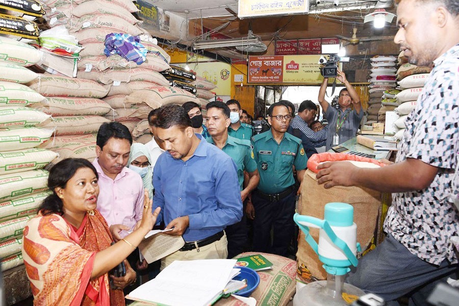 Food ministry officials conduct a drive against rice hoarders at Karwan Bazar wholesale market in the city on Wednesday — PID