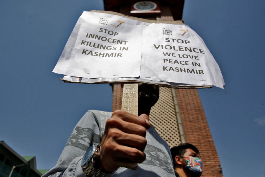 A demonstrator displays a placard during a protest against minorities killings in Kashmir, in Srinagar on June 2, 2022 — Reuters photo