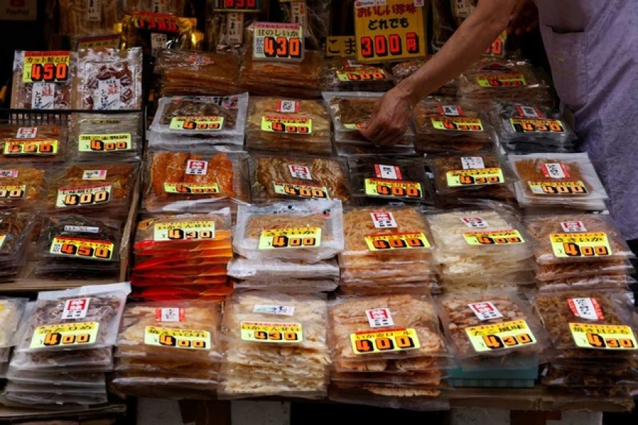 A vendor puts a price tag on a bag with dried sea food at a shop at the Ameyoko shopping district in Tokyo, Japan, May 20, 2022. REUTERS/Kim Kyung-Hoon