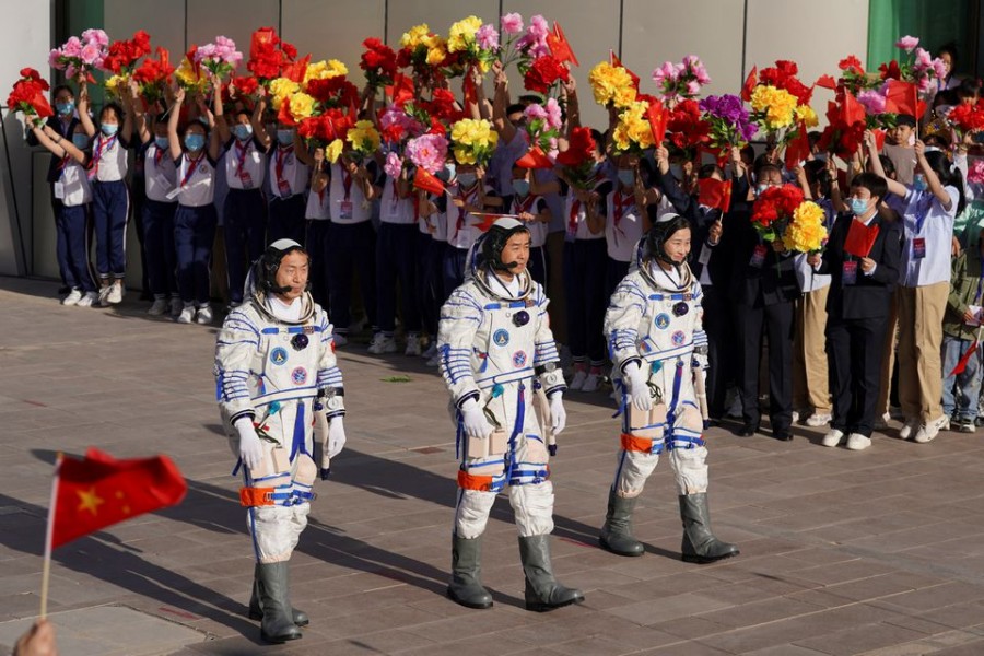 Chinese astronauts Chen Dong, Liu Yang and Cai Xuzhe attend a see-off ceremony before the launch of the Long March-2F carrier rocket, carrying the Shenzhou-14 spacecraft for a crewed mission to build China's space station, at Jiuquan Satellite Launch Center near Jiuquan, Gansu province, China June 5, 2022. China Daily via REUTERS