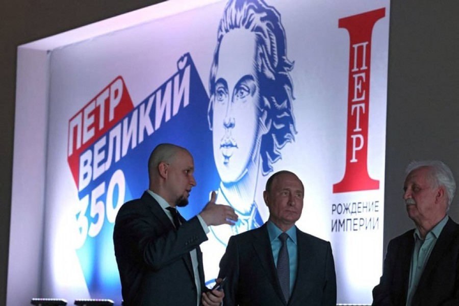 Russia's President Vladimir Putin listens to explanations as he visits an exhibition opened to mark the 350th birth anniversary of Russian tsar and the first Russian Emperor Peter the Great in Moscow, Russia June 9, 2022. Sputnik via REUTERS