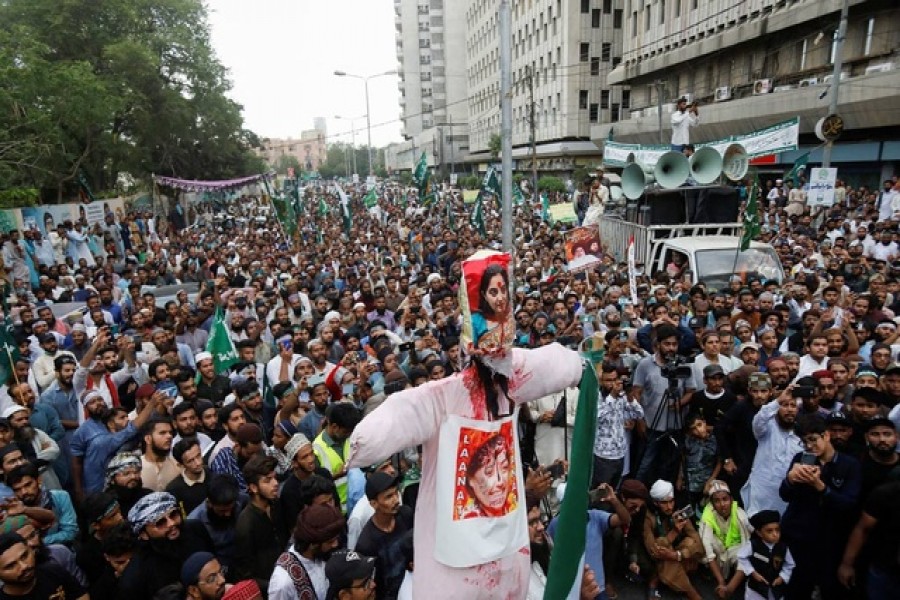 Supporters of the Tehreek-e-Labbaik Pakistan (TLP), a religious and political party, gather as an effigy depicting suspended Bharatiya Janata Party (BJP) spokeswoman Nupur Sharma is carried during a protest against the comments on Prophet Mohammed, in Karachi, Pakistan Jun 10, 2022. Reuters