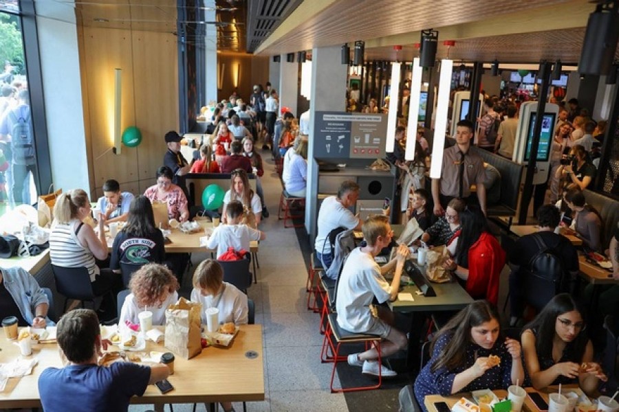 People visit the new restaurant "Vkusno & tochka", which opens following McDonald's Corp company's exit from the Russian market, in Moscow, Russia June 12, 2022. REUTERS