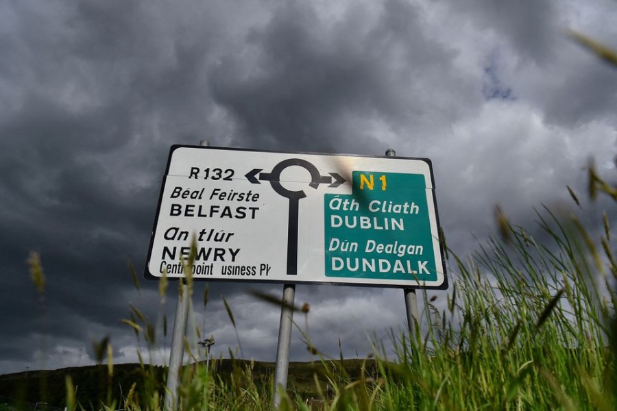 A road sign at a roundabout on the border between Northern Ireland and Ireland with directions to Belfast and Dublin is seen in Carrickcarnan, Ireland, May 19, 2022. REUTERS/Clodagh Kilcoyne/File Photo