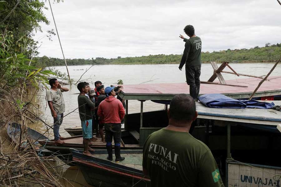 Indigenous people helping rescuers stand on a boat during the search operation for British journalist Dom Phillips and indigenous expert Bruno Pereira, who went missing while reporting in a remote and lawless part of the Amazon rainforest, near the border with Peru, in Amazonas state of Brazil on Sunday –Reuters file photo