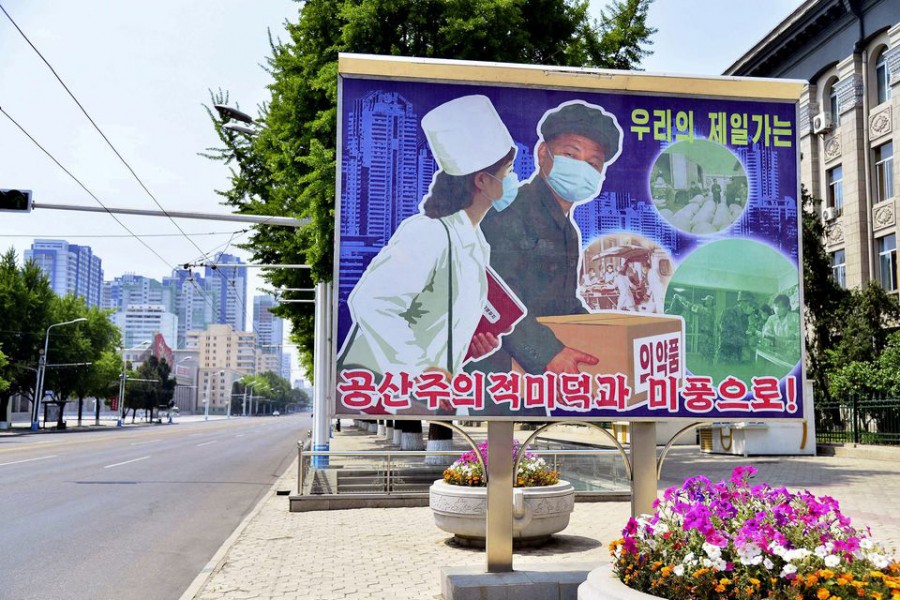 A sign depicting a scene of medical products transportation is displayed at the empty street, amid growing fears over the spread of coronavirus disease (Covid-19), in Pyongyang, North Korea, in this photo released by Kyodo on May 23, 2022 — Kyodo via REUTERS/Files