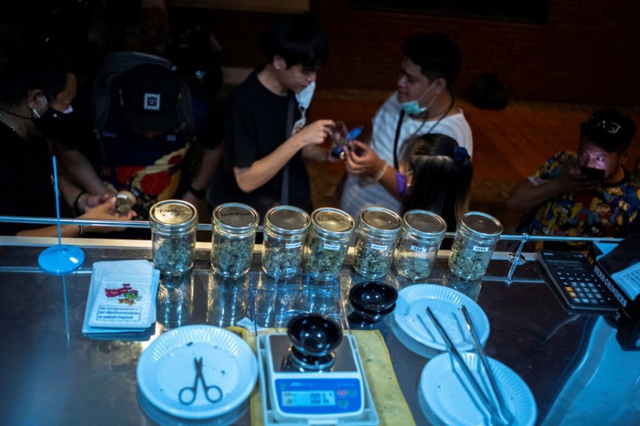 Customers queue to buy cannabis at the Happy Bud, a cannabis truck at Khaosan Road, one of the favourite tourist spots in Bangkok, Thailand, after it was removed from the narcotics list under Thai law, June 13, 2022. REUTERS/Athit Perawongmetha