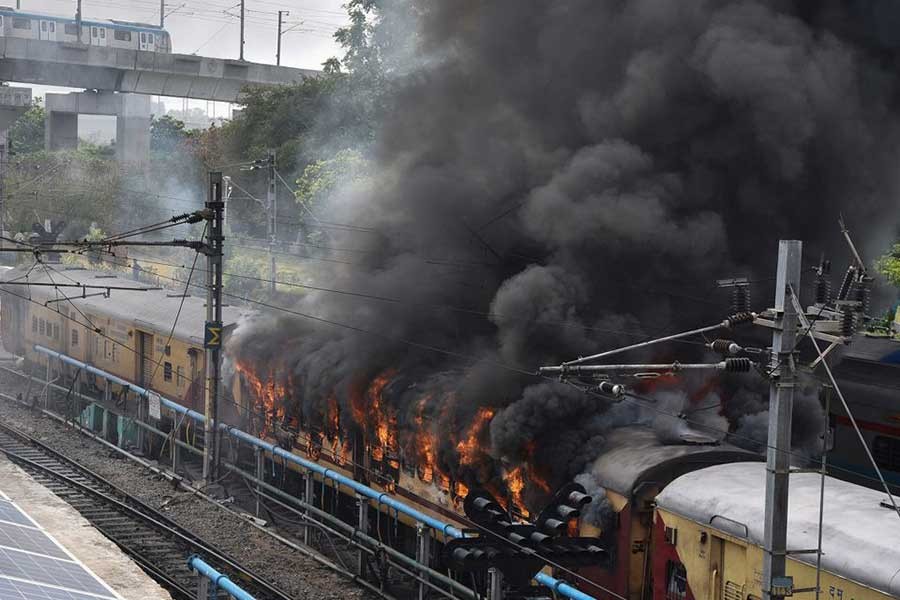 Smoke billowing out from a passenger train coach after it was set on fire by protestors during a protest against "Agnipath scheme" for recruiting personnel for armed forces, in Secunderabad in the southern state of Andhra Pradesh, in India on Friday –Reuters photo