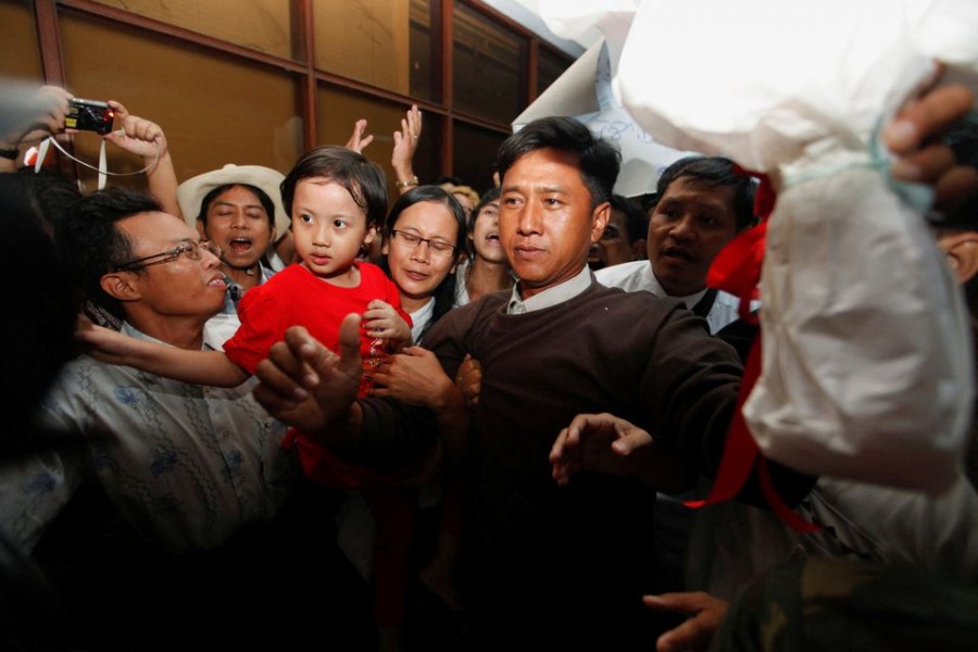 Kyaw Min Yu (2nd R), released from Taunggyi prison, and his wife Nilar Thein (4th R), released from Thar Yar Waddi prison, carry their daughter as they arrive in Yangon domestic airport in Yangon, Myanmar January 13, 2012. Jimmy and Nilar are both activists from the 88 Generation Students Group. REUTERS/Soe Zeya Tun/File Photo