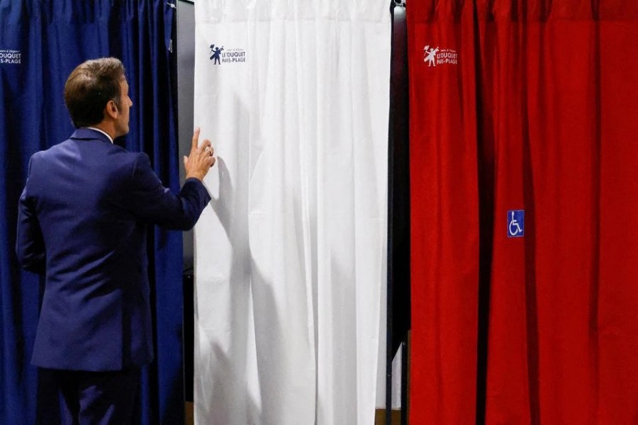 French President Emmanuel Macron enters a polling booth to cast his vote during the first round of French parliamentary elections, at a polling station in Le Touquet, France, June 12, 2022. Ludovic Marin/Pool via REUTERS//File Photo