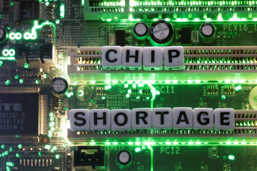Plastic letters arranged to read "Chip Shortage" are placed on a computer motherboard in this illustration taken, February 20, 2022. REUTERS/Dado Ruvic/Illustration