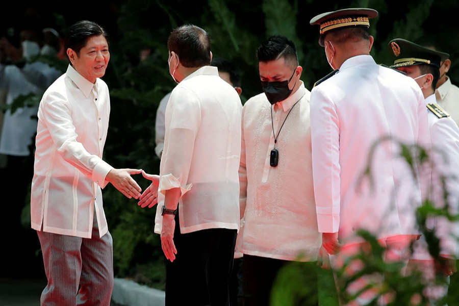 Incoming Philippine President Ferdinand 'Bongbong' Marcos Jr. shakes hands with outgoing President Rodrigo Duterte during the inauguration ceremony, at the Malacanang palace grounds, in Manila, Philippines on June 30, 2022 — Pool via Reuters