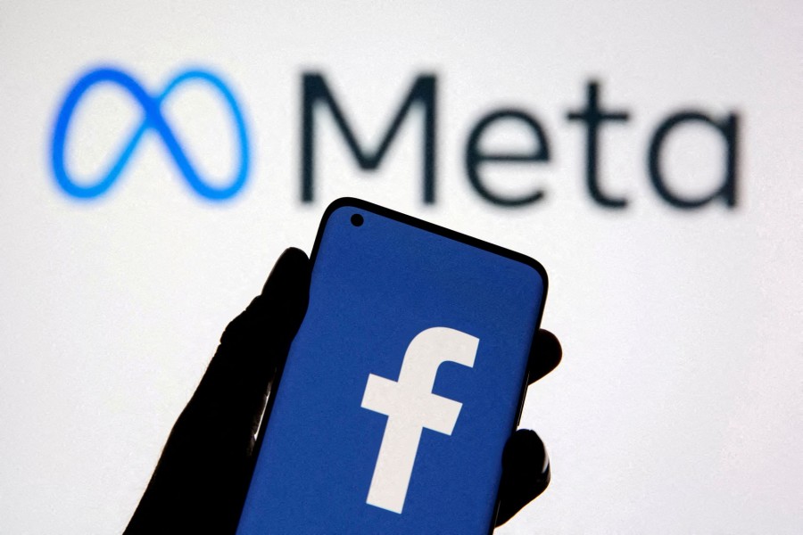 A smartphone with Facebook's logo is seen with new rebrand logo Meta in this illustration taken on October 28, 2021 — Reuters/Files