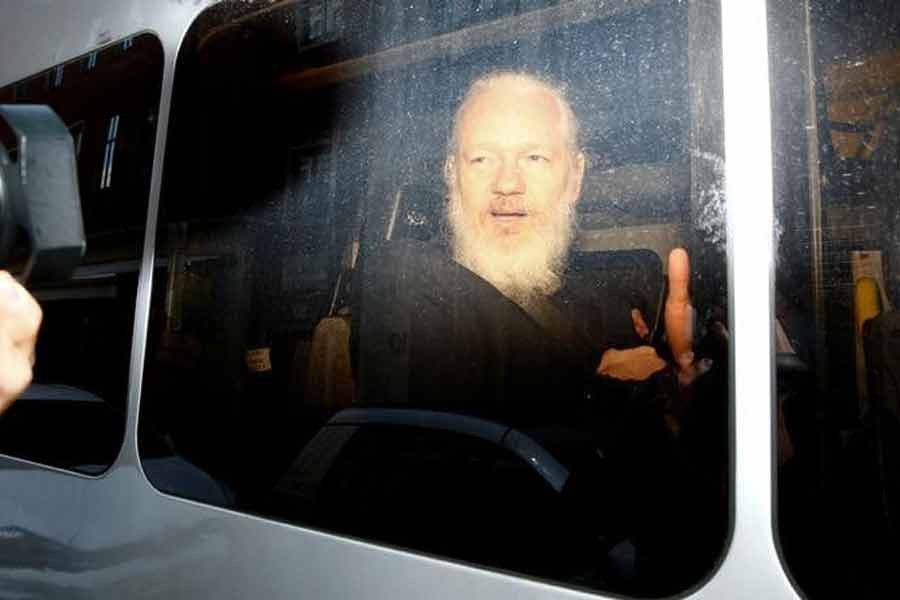 WikiLeaks founder Julian Assange is seen in a police van, after he was arrested by British police, in London in 2019 –Reuters file photo