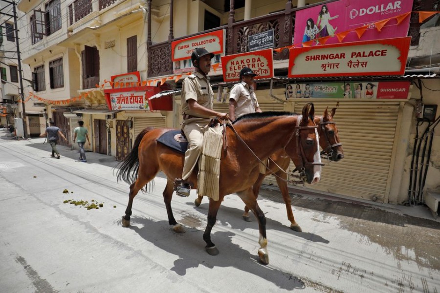 Policemen mounted on their horses patrol during restrictions imposed by authorities after the killing of Kanhaiya Lal Teli, a Hindu tailor, carried out by two suspected Muslim men who filmed the act and posted it online, in Udaipur in the northwestern state of Rajasthan, India, July 1, 2022. REUTERS/Amit Dave