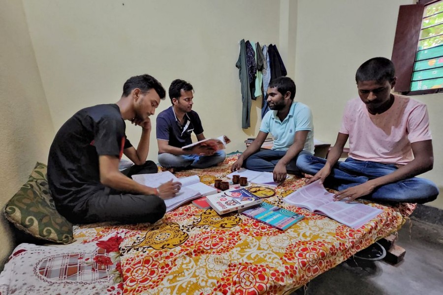 Government job aspirants Rahul Patel, Prem Prakash, Ravi Ranjan and Gupteshwar Kumar take part in a group study as they prepare for examinations for railway jobs in a rented room in Arrah, in the eastern state of Bihar, India, June 25, 2022. REUTERS/Saurabh Sharma