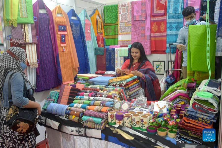 Exhibitors arrange products at a stall during Bangladesh's National Small and Medium Enterprise (SME) Fair in Dhaka, capital of Bangladesh, on Dec. 5, 2021. 	—Xinhua Photo