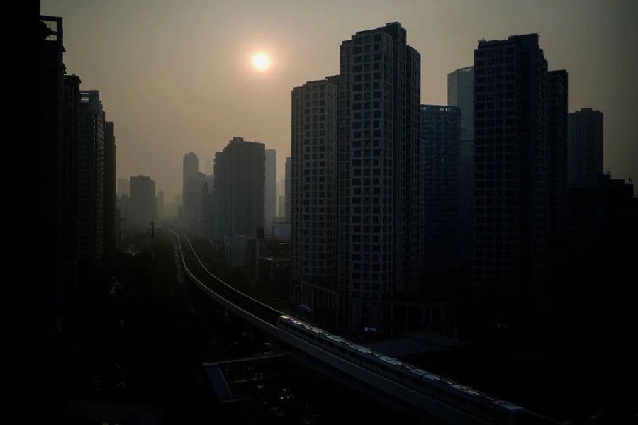 Buildings are seen at sunset, almost a year after the global outbreak of the coronavirus disease (COVID-19) in Wuhan, Hubei province, China December 12, 2020. REUTERS/Aly Song