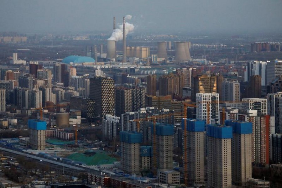 Residential buildings under construction and a power station are seen near the central business district in Beijing, China, January 15, 2021 — Reuters