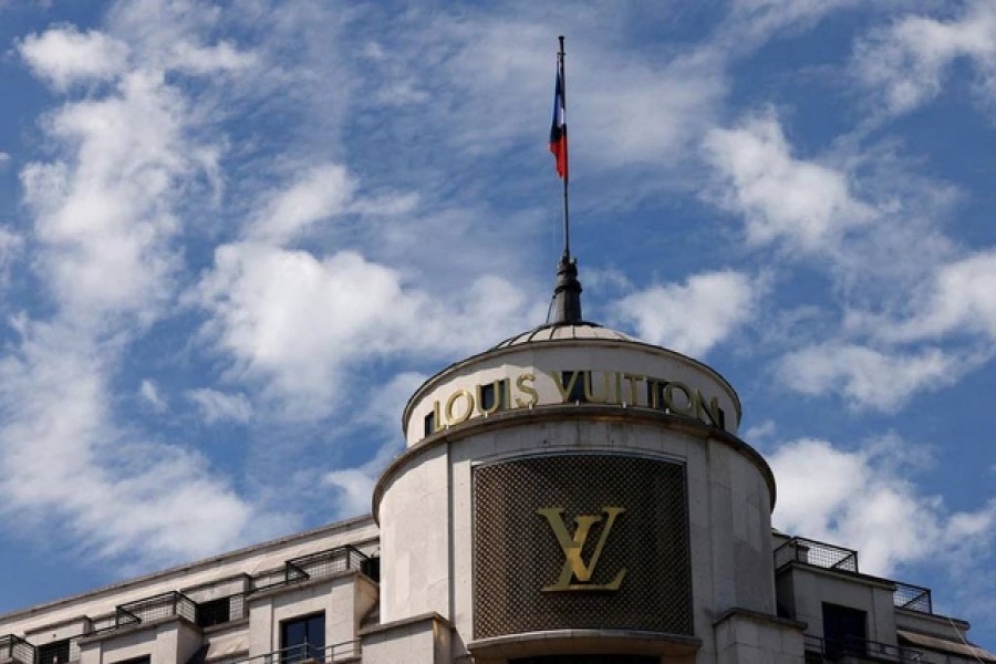 Louis Vuitton logo is seen on a store on the Champs-Elysees avenue in Paris, France, Jul 13, 2022. Reuters