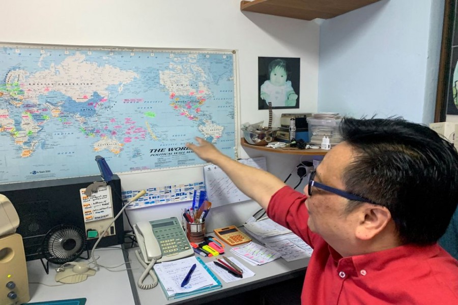 Kelvin Pang, a Singapore-based electronics broker, points to a map in his office in Singapore, June 24, 2022. REUTERS/Kevin Krolicki